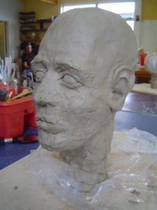 Putting on the facial features, stage 3, side view.